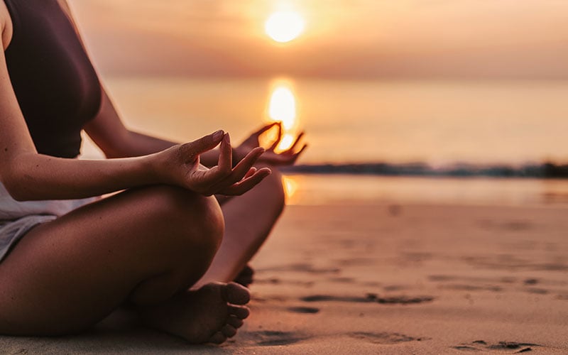 woman-meditating-at-beach-during-sunset-800x500opt-1475415338